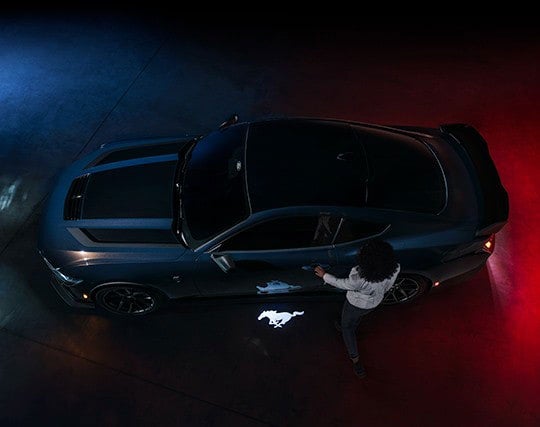 2024 Ford Mustang® Dark Horse™ model with a driver approaching the vehicle | Keyser & Miller Ford Inc in Collegeville PA