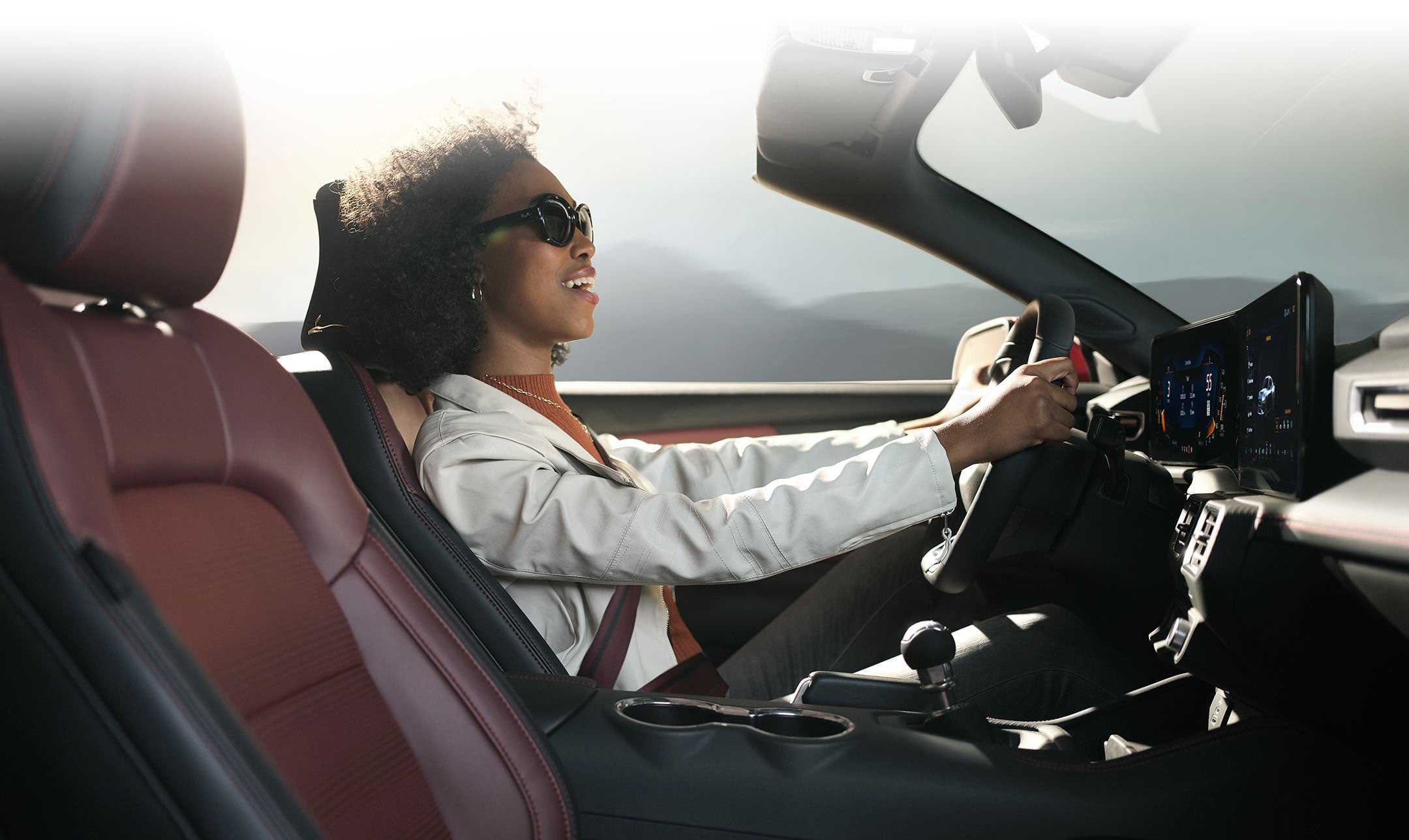 Person sitting in the driver’s seat of a 2024 Ford Mustang® convertible | Keyser & Miller Ford Inc in Collegeville PA