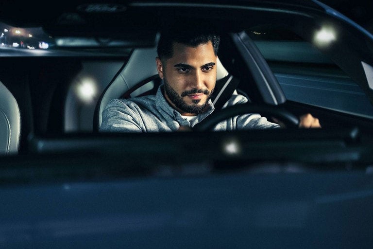 Person sitting in the driver’s seat of a parked 2024 Ford Mustang® coupe | Keyser & Miller Ford Inc in Collegeville PA